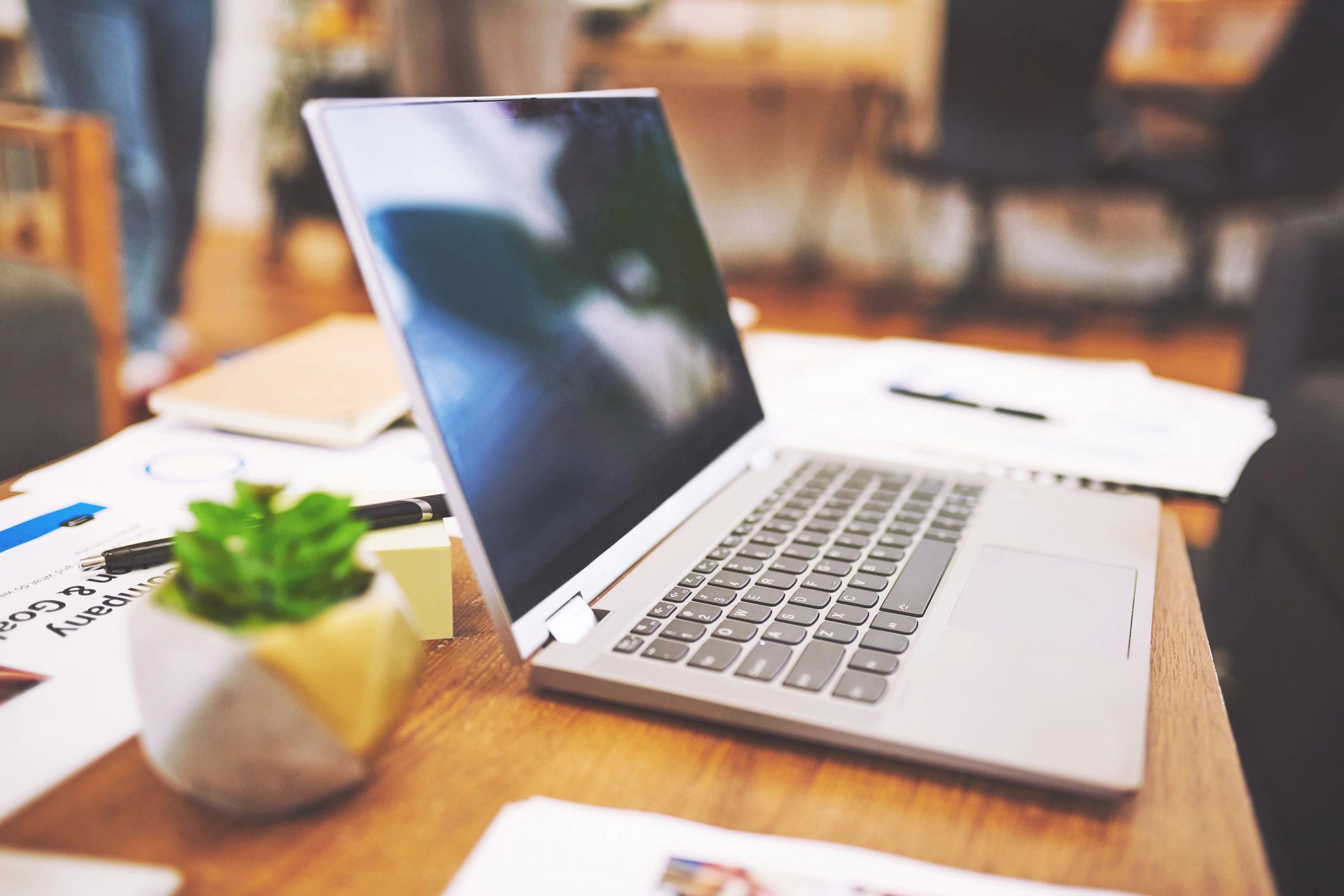 Laptop and planning paperwork on a desk